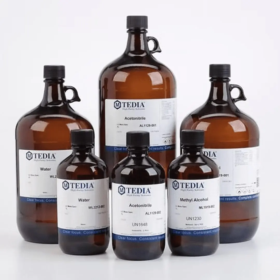 A selection of Tedia High Purity Solvents in amber glass bottles of various sizes